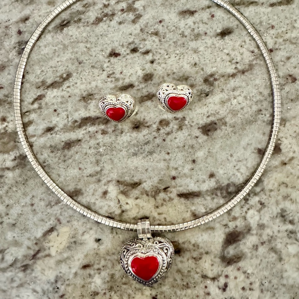 Red and silver tone heart shape necklace and pierced earring set .